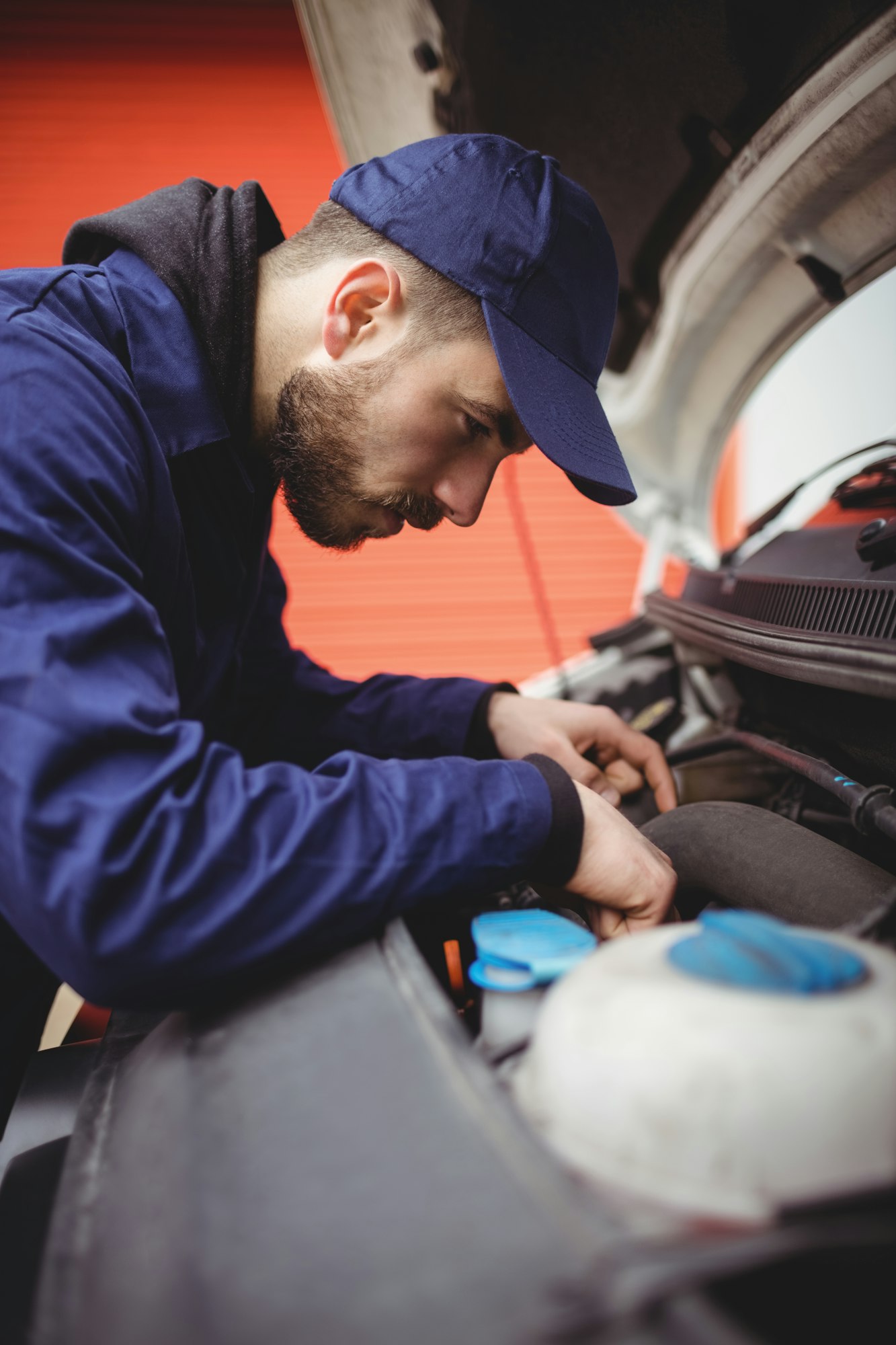 Mechanic fixing the engine of a van